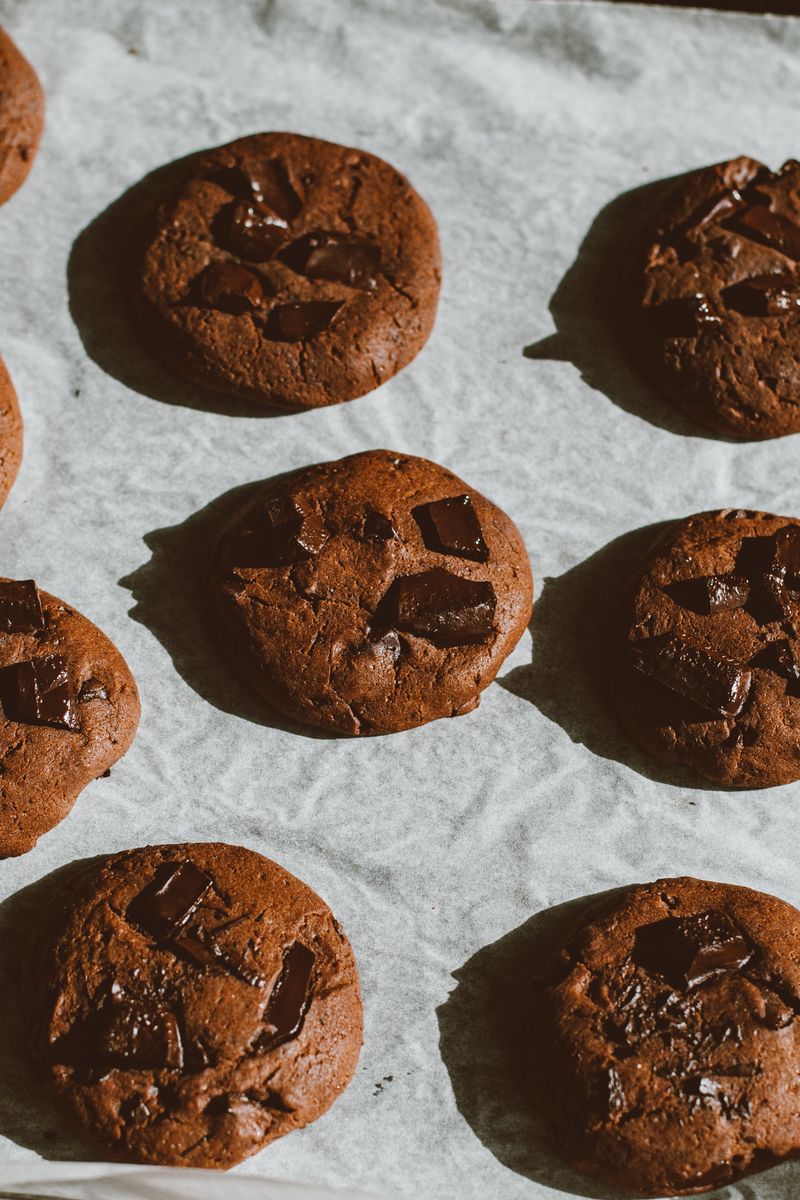 Delicious homemade chocolate chip cookies freshly baked and cooling on a tray.